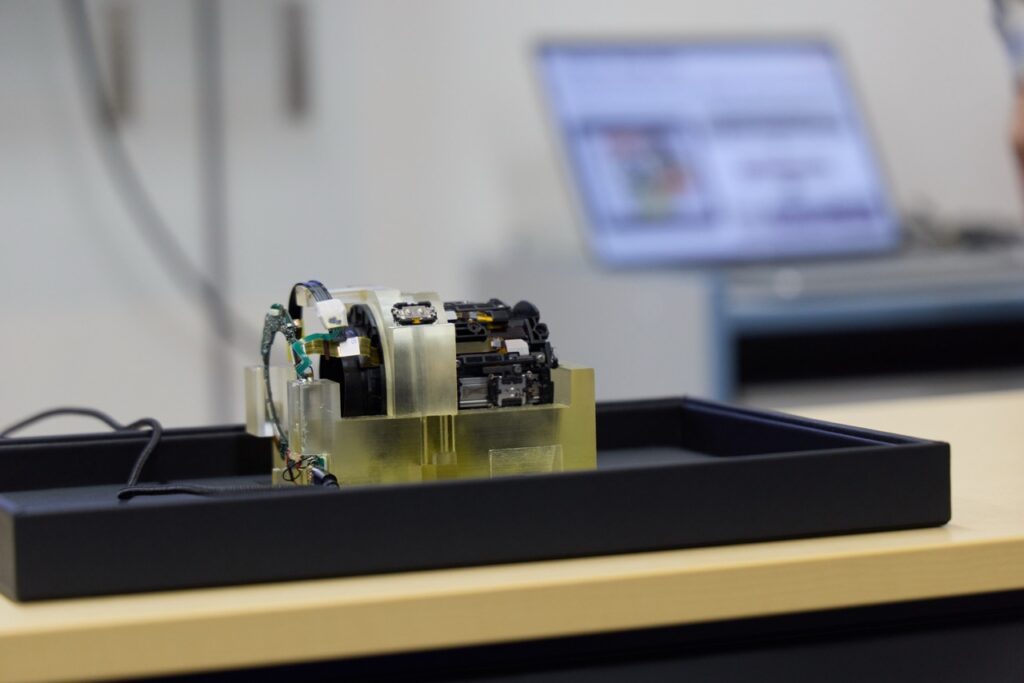 The inside of a Canon telephoto lens shows the linear motors that drive the focus elements.