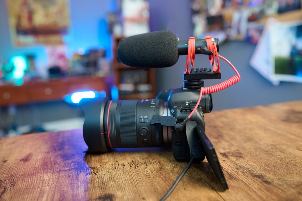 CAnon R6 III on a table with audio gear on top of the camera. 